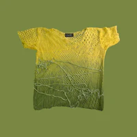 a yellow t - shirt on a green background