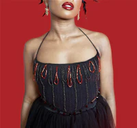 a black woman in a black dress with dreadlocks